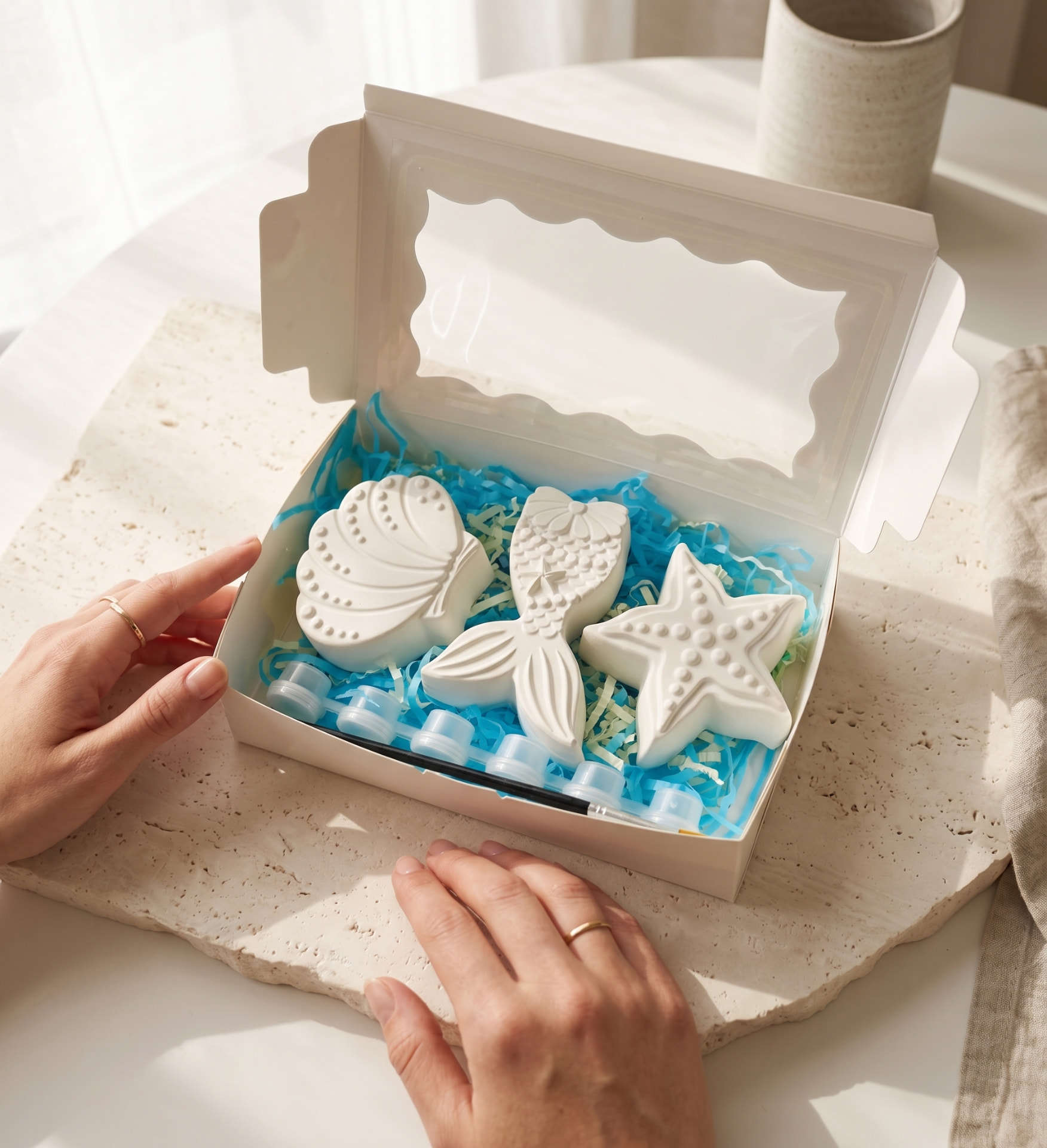 An open Under the Sea plaster painting kit presented with unpainted shell, mermaid tail and starfish pieces